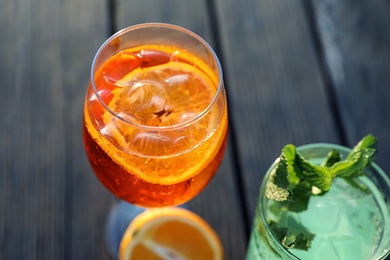 Glasses of fresh summer cocktails on wooden table, closeup