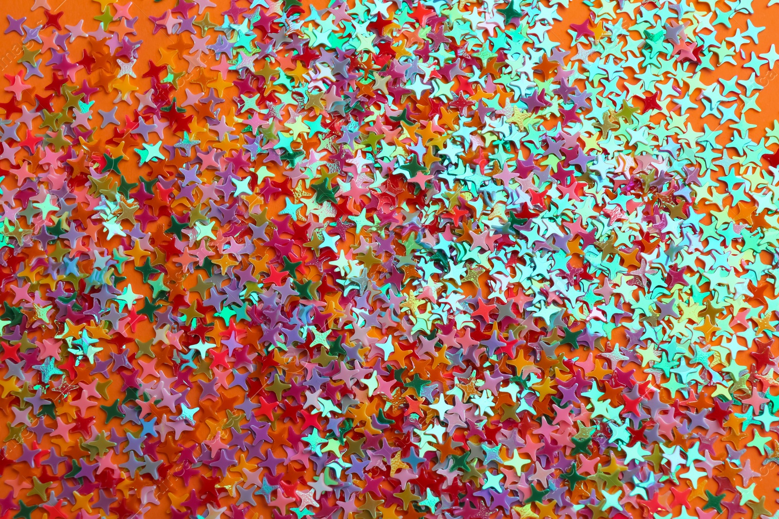 Photo of Shiny bright colorful glitter as background, top view