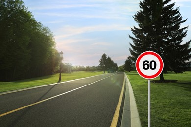 Image of Traffic sign MAXIMUM SPEED 60 near empty asphalt road on sunny day