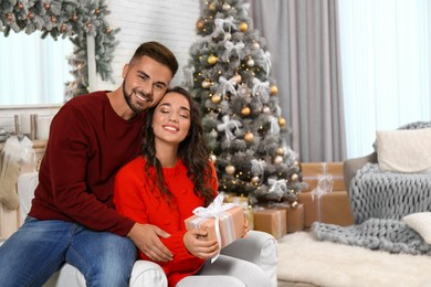 Image of Lovely couple celebrating Christmas together at home
