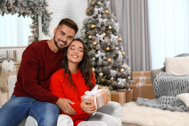 Lovely couple celebrating Christmas together at home