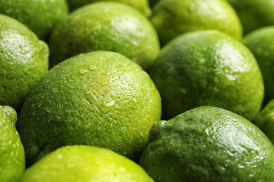 Photo of Fresh ripe juicy limes as background, closeup