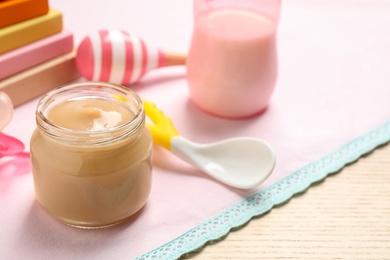 Healthy baby food in jar on table. Space for text