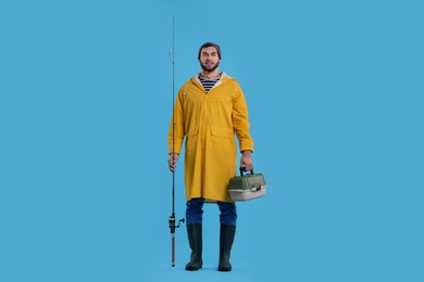 Fisherman with rod and tackle box on light blue background