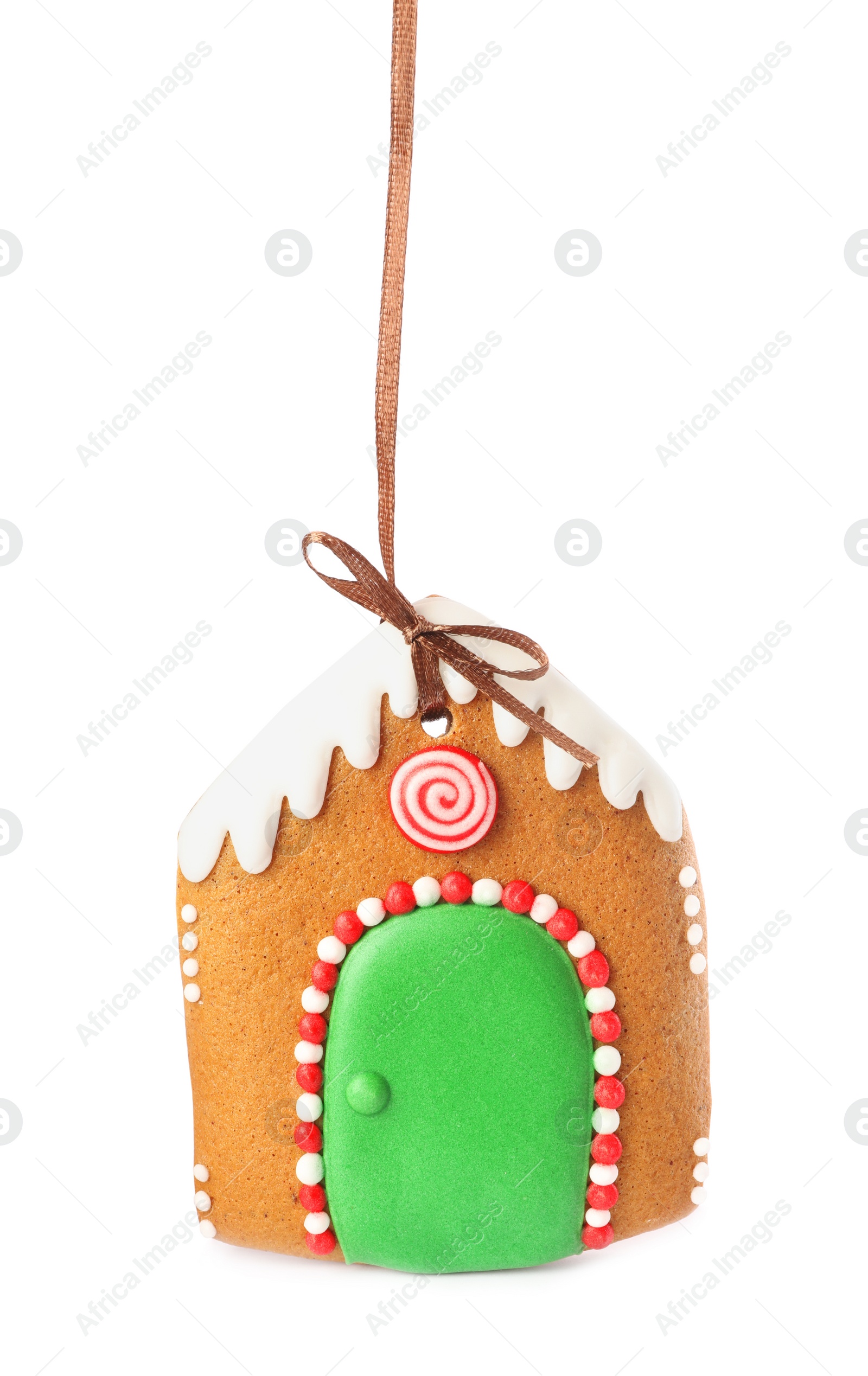 Photo of House shaped Christmas cookie with string isolated on white