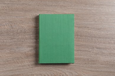 Photo of Hardcover book on wooden table, top view