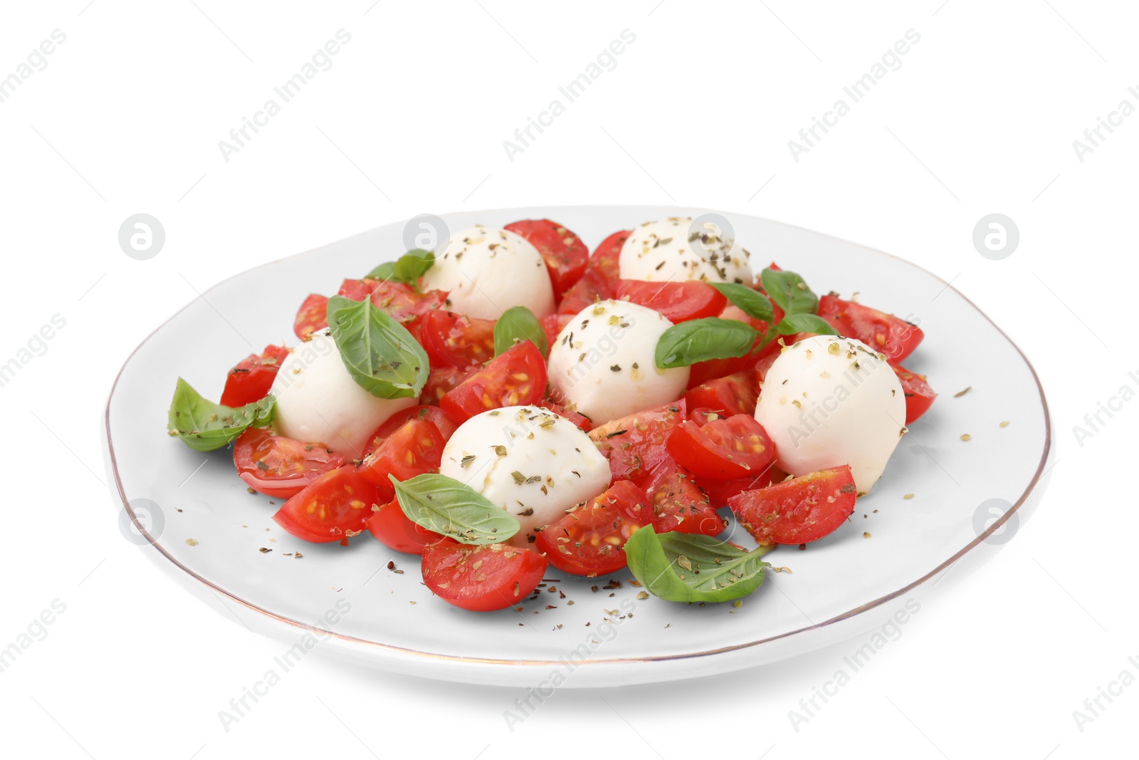 Photo of Plate of tasty salad Caprese with tomatoes, mozzarella balls and basil isolated on white