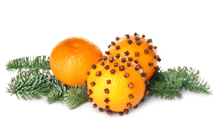 Photo of Pomander balls, tangerine and fir tree branches on white background