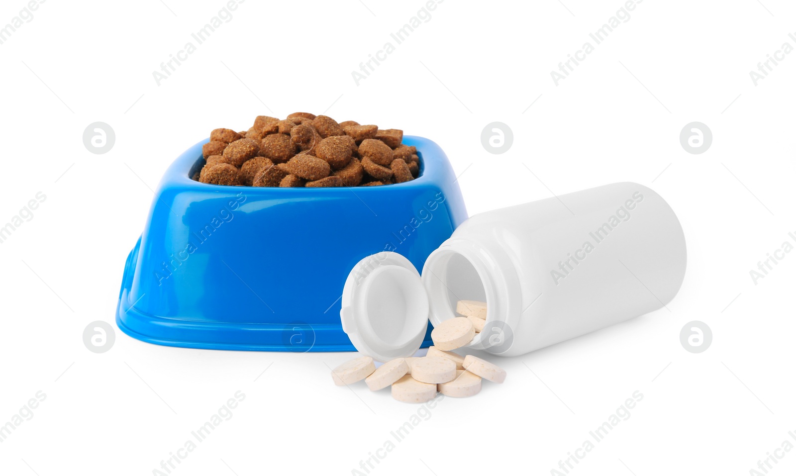 Photo of Dry pet food in bowl, vitamins and bottle isolated on white