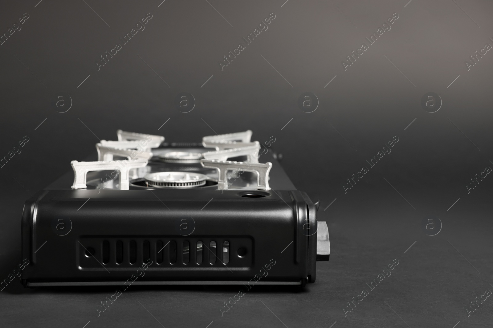 Photo of Portable gas stove on grey background, space for text. Military equipment