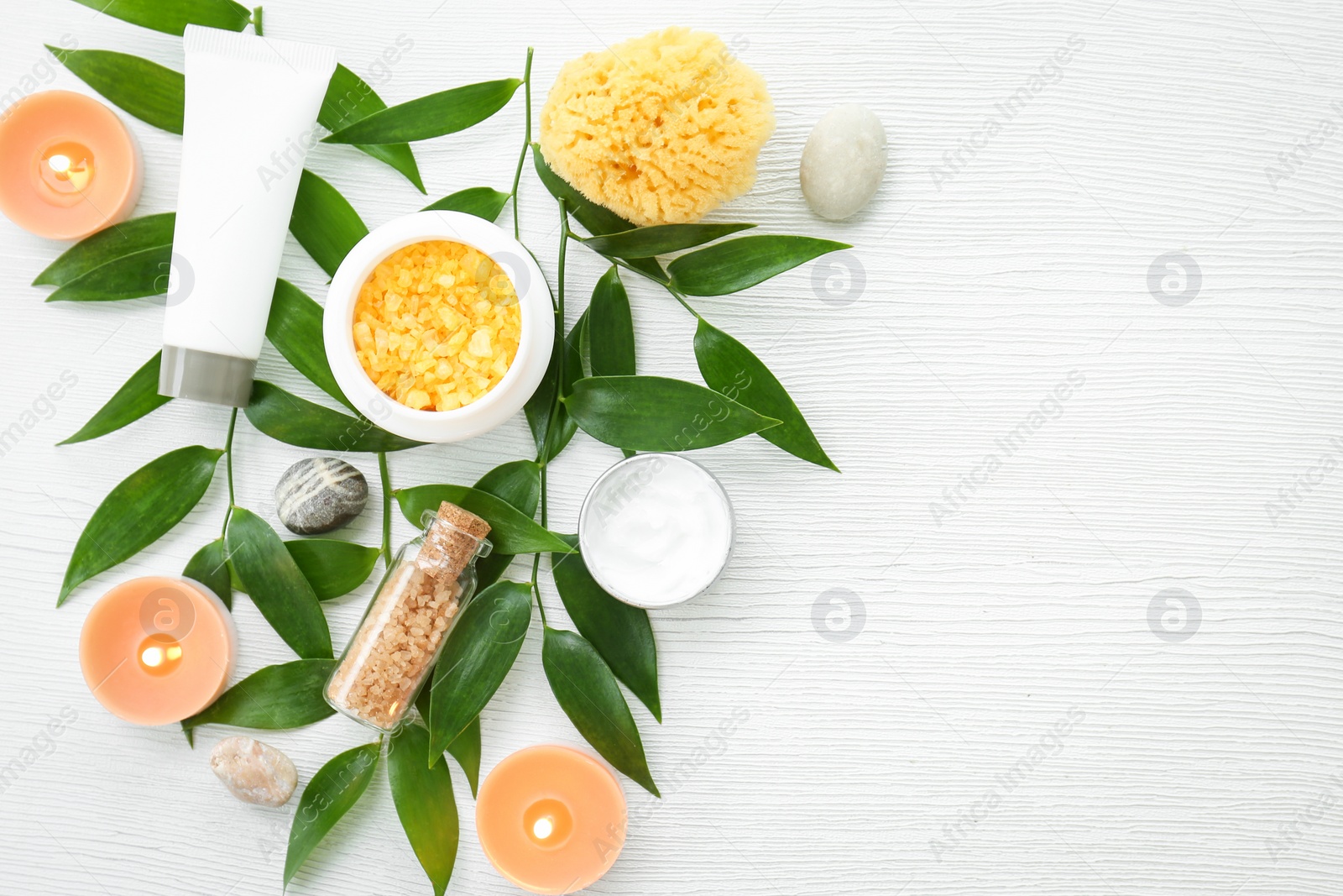 Photo of Beautiful composition with spa cosmetics and candles on light background