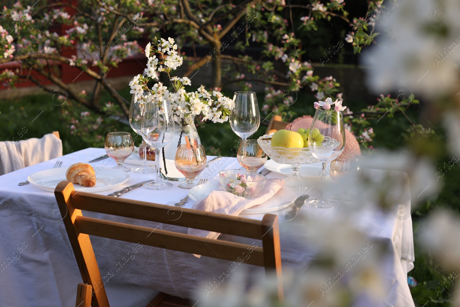 Photo of Stylish table setting with beautiful spring flowers in garden