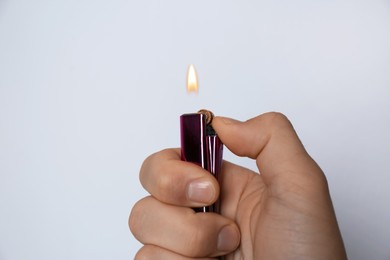 Man holding lighter on white background, closeup