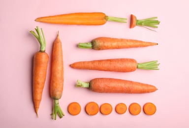 Photo of Flat lay composition with fresh carrots on color background