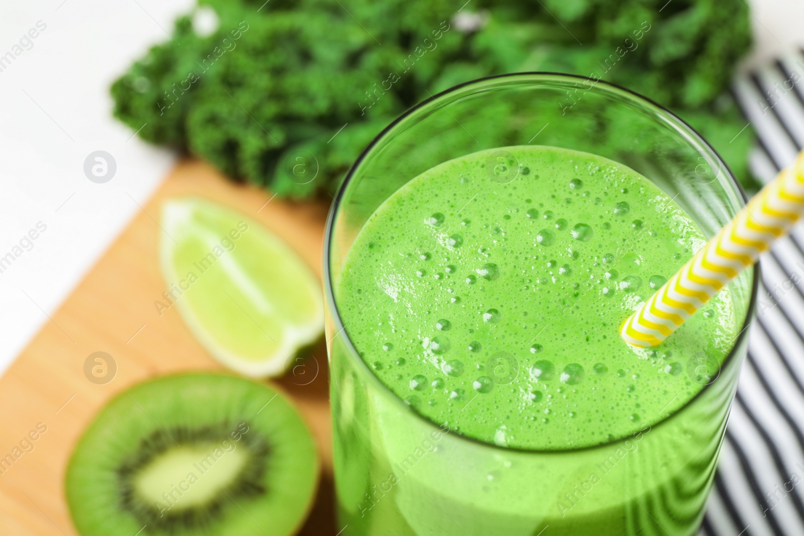 Photo of Tasty fresh kale smoothie on table, closeup