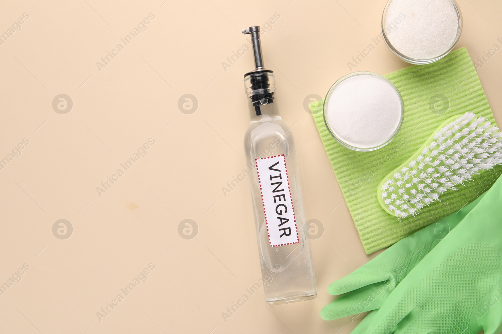 Photo of Eco friendly natural cleaners. Flat lay composition with bottle of vinegar on beige background, space for text