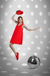 Image of Beautiful young woman dancing near disco ball on spotted background. Bright stylish design