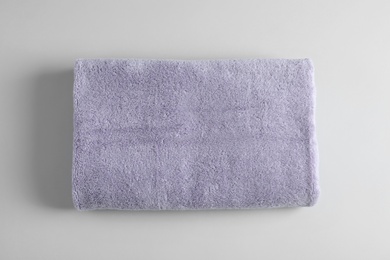 Photo of Fresh fluffy towel on grey background, top view. Mockup for design