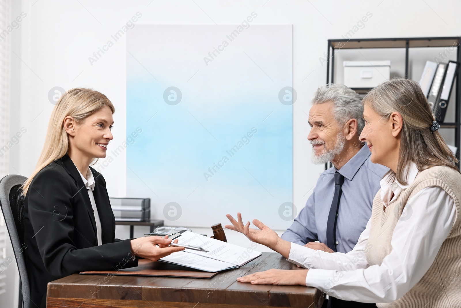 Photo of Senior couple having meeting with lawyer in office