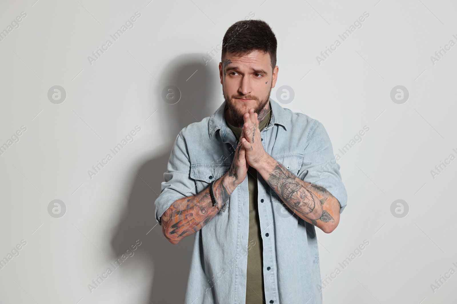 Photo of Handsome hipster man on light grey background. Space for text