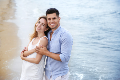 Photo of Happy couple on beach, space for text. Romantic walk