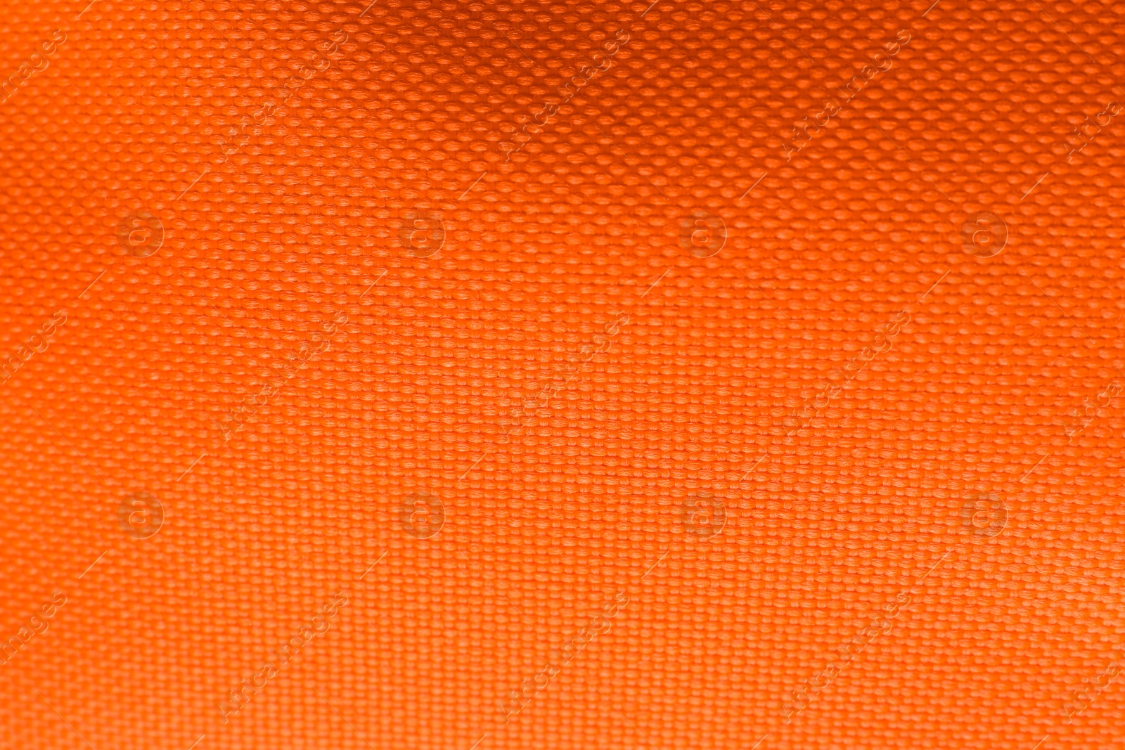 Photo of Texture of beautiful orange fabric as background, closeup view