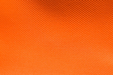 Photo of Texture of beautiful orange fabric as background, closeup view