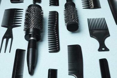 Photo of Composition with modern hair combs and brushes on light background