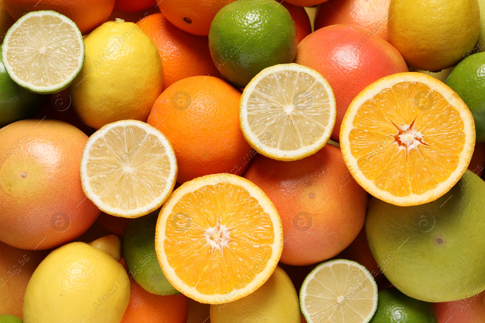 Photo of Different fresh citrus fruits as background, top view