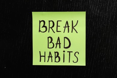 Photo of Paper note with phrase Break bad habits on black board, closeup