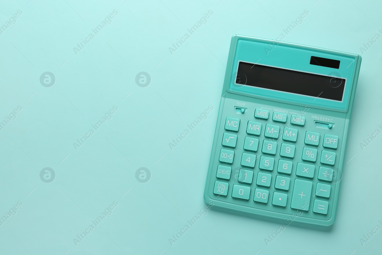 Photo of Turquoise calculator on light blue background, top view. Space for text