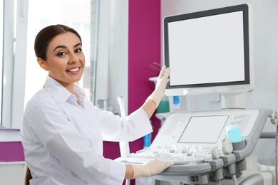 Photo of Sonographer using modern ultrasound machine in clinic