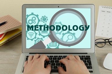 Image of Methodology concept. Woman using modern laptop at table indoors, closeup