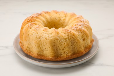 Photo of Delicious freshly baked sponge cake on white table, closeup