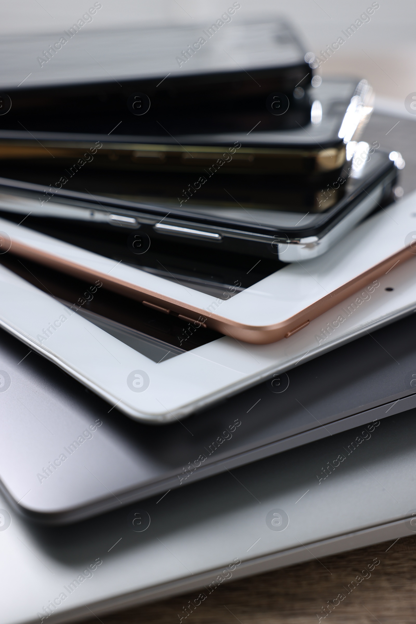 Photo of Many different modern gadgets on wooden table, closeup