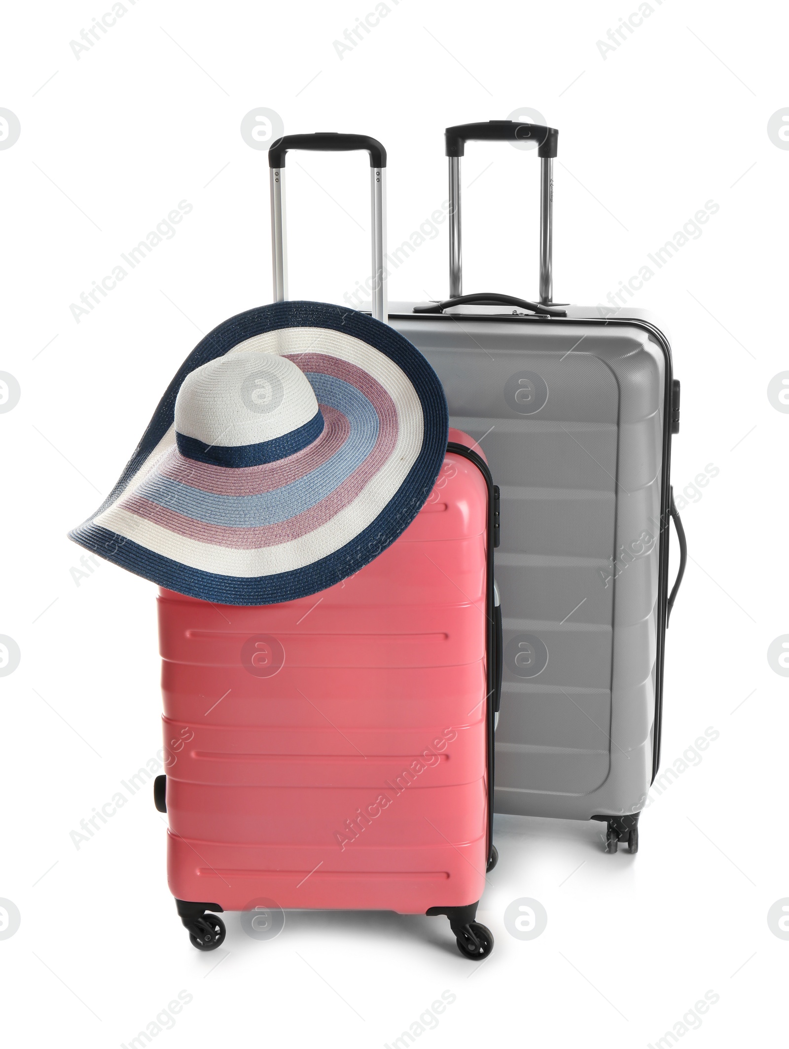 Photo of Suitcases and hat on white background. Travel preparation