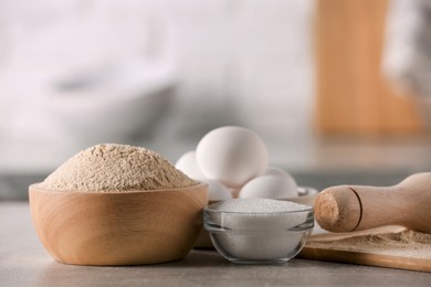 Photo of Bowl of buckwheat flour, sugar and eggs on table indoors