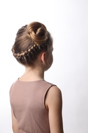 Little girl with braided hair on white background, back view