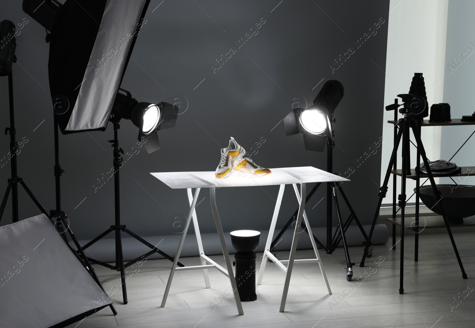 Photo of Professional photography equipment prepared for shooting stylish shoes in studio