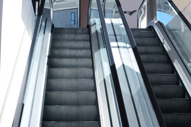 Photo of Modern escalators with handrails in shopping mall