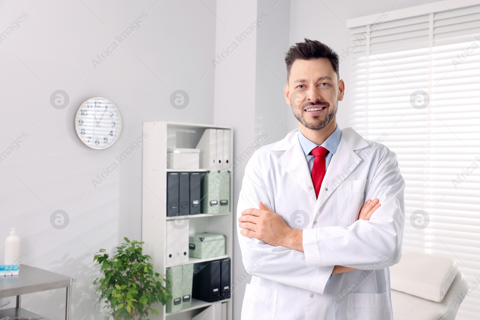 Photo of Happy doctor in clinic, space for text. Patient consultation