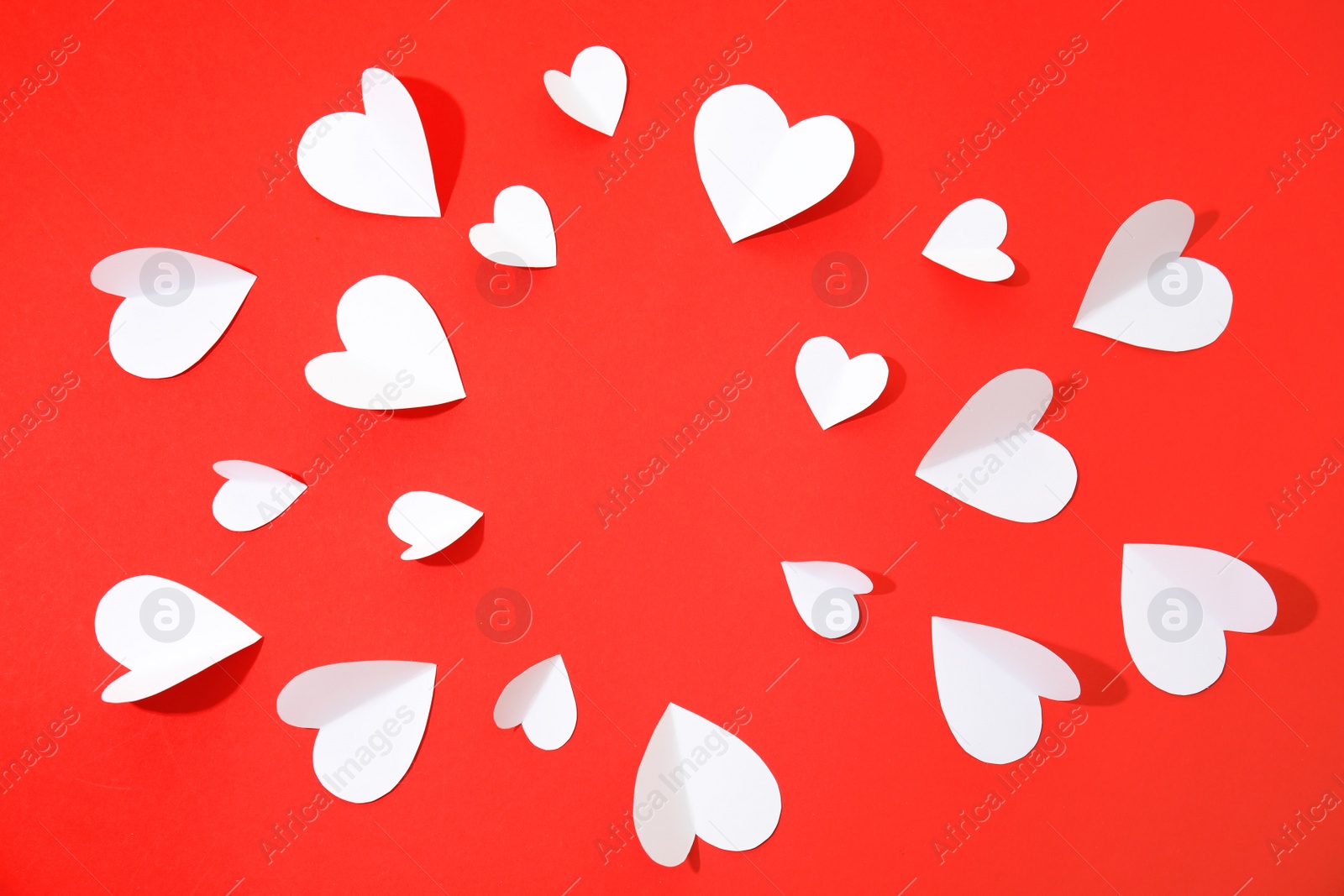 Photo of Small paper hearts on color background, top view