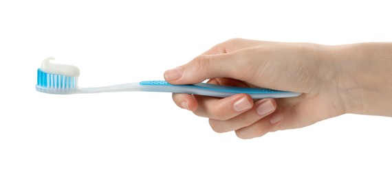 Photo of Woman holding toothbrush with paste on white background, closeup