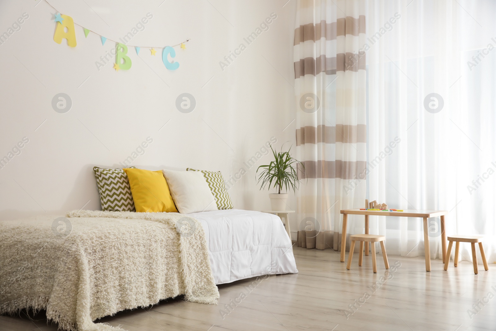 Photo of Modern child room interior with comfortable bed