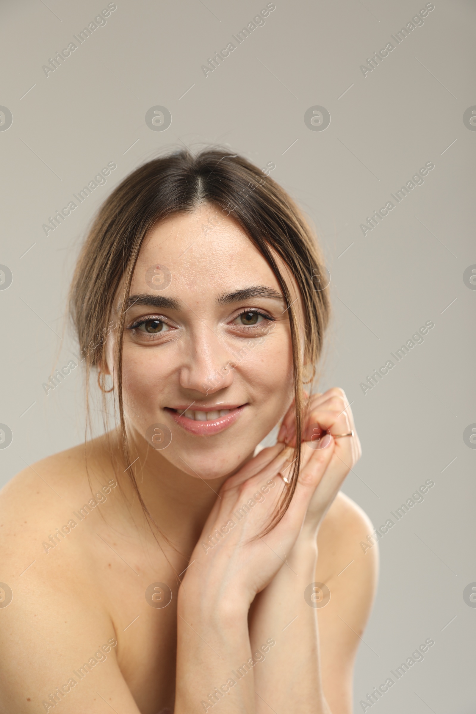 Photo of Portrait of beautiful woman on grey background