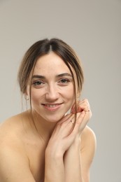 Portrait of beautiful woman on grey background