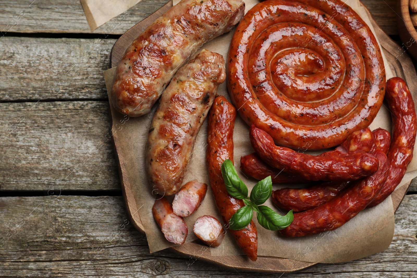 Photo of Set of different tasty snacks on wooden table, top view