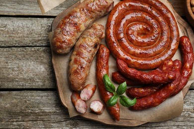 Set of different tasty snacks on wooden table, top view