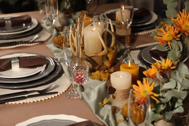 Photo of Table set with beautiful autumn decor for festive dinner
