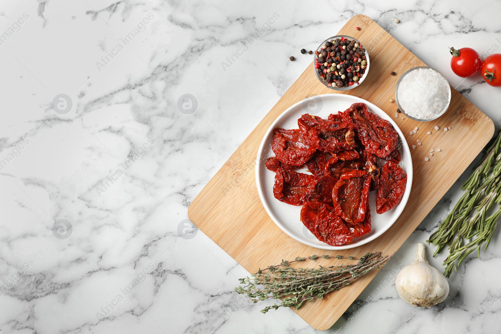 Photo of Flat lay composition with dried tomatoes and space for text on marble table